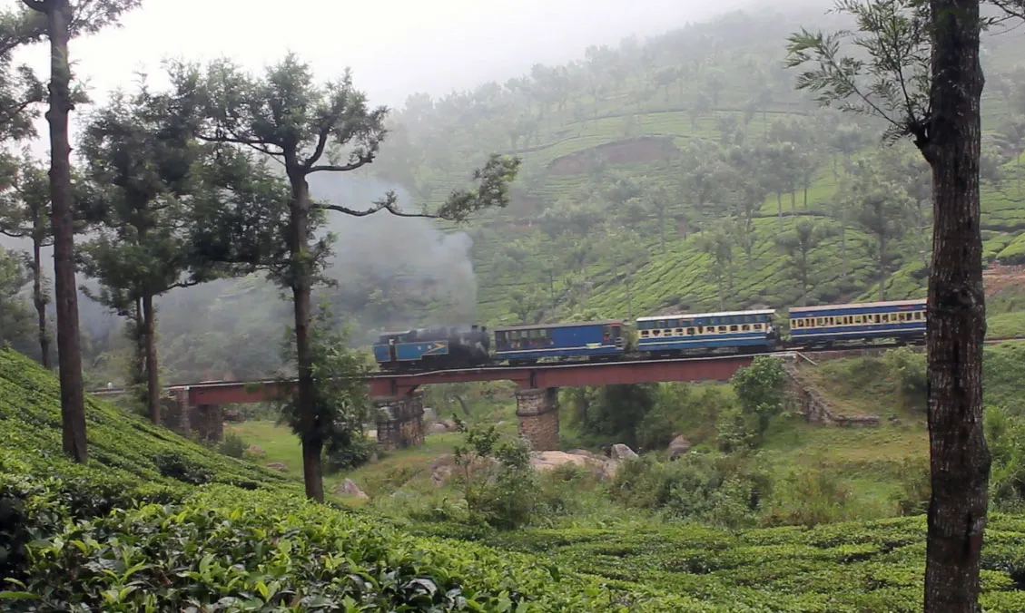 A taxi on a misty hairpin road climbing towards Ooty